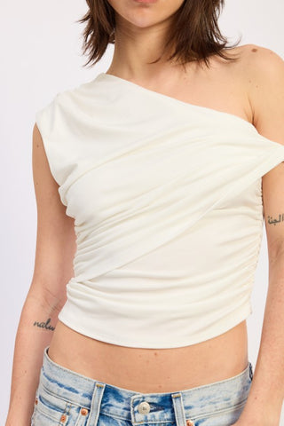 close up cream one shoulder crop top showing fabric shoulder twist detail and horizontal ruching across fitted torso