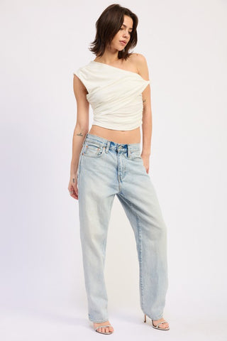 full length side view cream one shoulder crop top with wide leg jeans and heeled sandals showing waist crop length