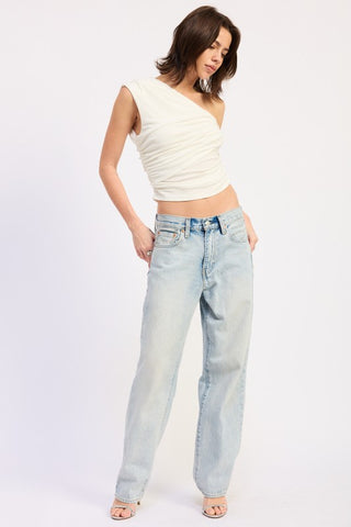 close up upper body cream one shoulder crop top showing diagonal drape and exposed shoulder silhouette
