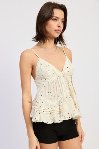 three-quarter view showing tiered ruffle hem tiers and overall relaxed fit