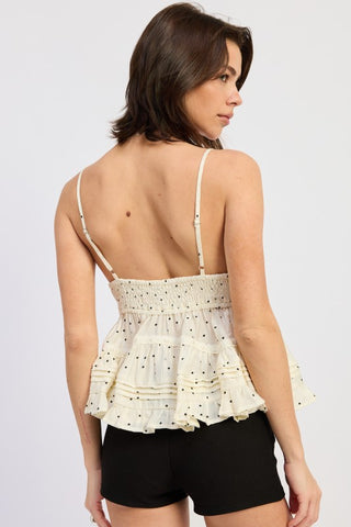 detail shot tiered pintuck ruffle hem and lace trim on ivory polka dot cami top