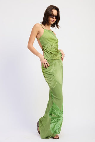 full length editorial model in tonal green orchid co-ord, matching open back mesh top and mermaid maxi skirt