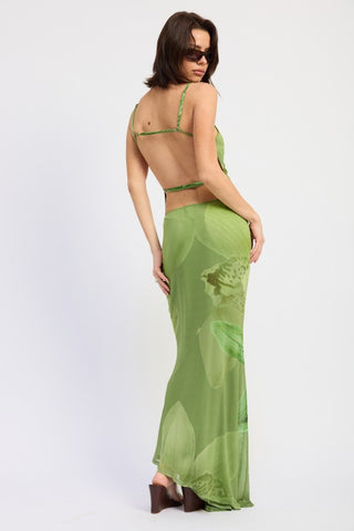 editorial pose model in tonal green botanical print maxi mermaid skirt and matching mesh top, movement shot