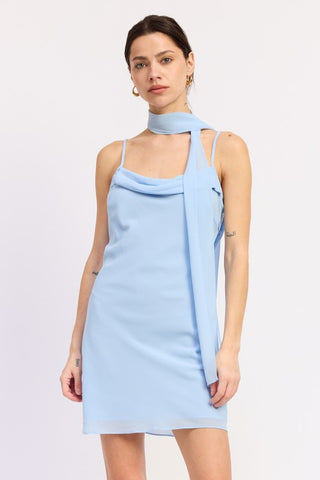 model in motion wearing cowl drape chiffon mini dress with floating scarf panel visible in movement