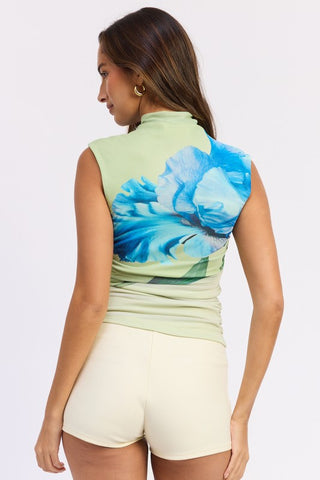 portrait close up model in Iris sage green blue floral mesh crop top showing macro iris print and mock neck collar