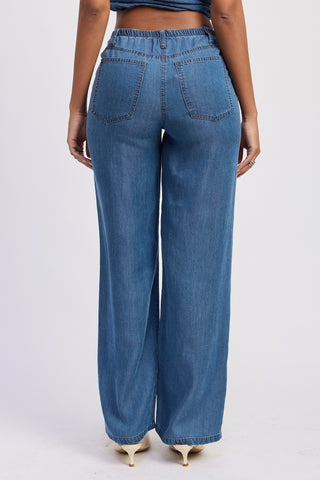 Blue jeans worn by a person on a white background