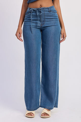 Blue jeans worn by a person on a white background