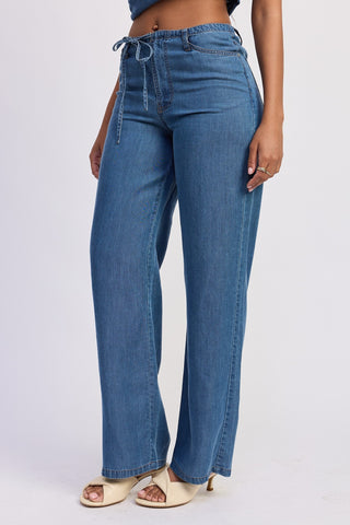 Blue jeans worn by a person on a white background