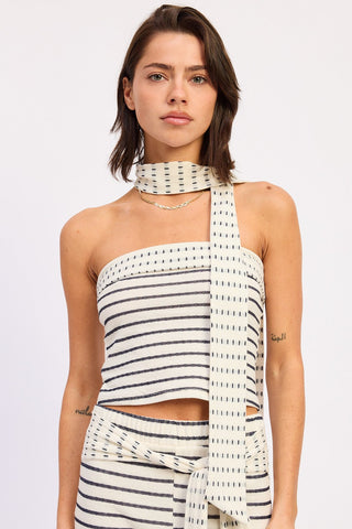 Woman wearing a striped halter top with a scarf on a white background