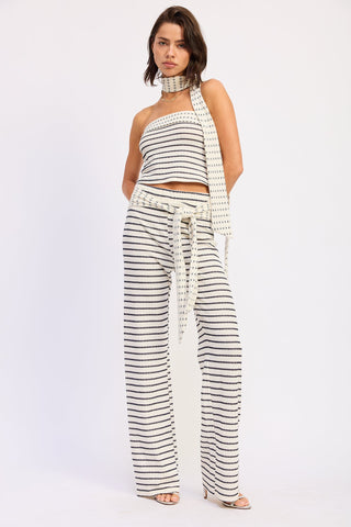 Woman wearing a black and white striped outfit on a white background