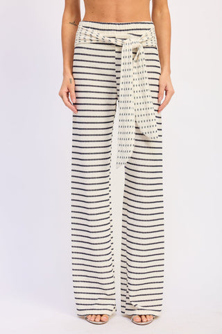 Striped wide-leg pants worn by a person on a white background