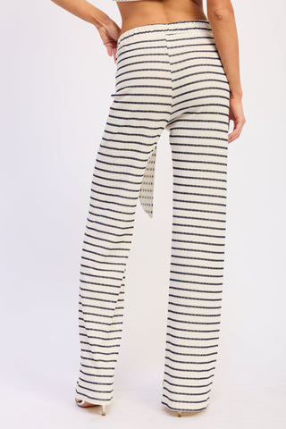 Striped pants worn by a person on a white background