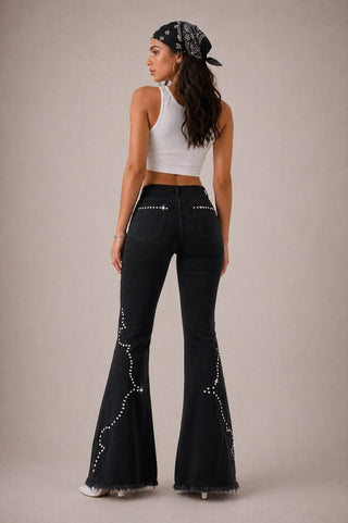 Close detail embroidery on black bell bottom jeans GJG LA dye house custom black