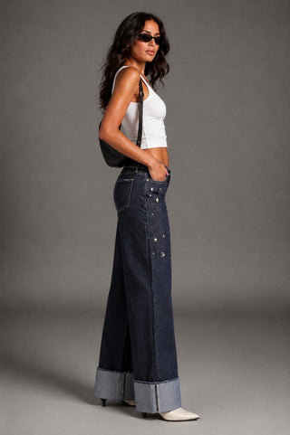 Side profile Sierra dark blue wide leg jeans oversized cuff stud scatter