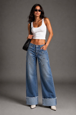 Close detail scattered silver studs medium blue wide leg jeans oversized cuff