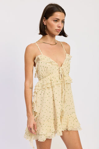 Woman wearing a light yellow Romper with polka dot patterns on a white background