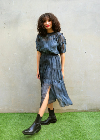 Model walking in navy tiered midi dress showing fluid movement of fabric