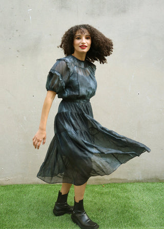 Side view of navy tie-dye dress showing movement and side slit detail
